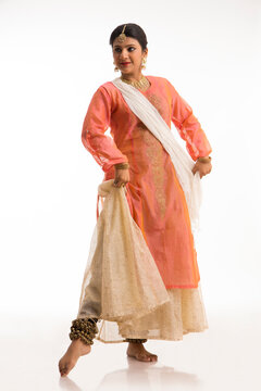 Graceful Kathak dancer giving a mesmerising performance in front of a white background. 