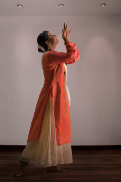 Beautiful kathak dancer performing gracefully at home.
