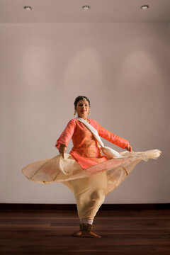 Gorgeous kathak dancer circling and smiling.  
