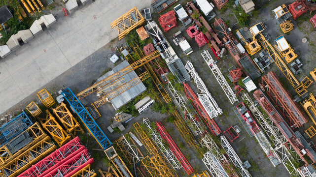 Aerial view of the Feluy de Parc Industriel featuring a collection of colorful construction cranes and industrial equipment stored in an open yard in Seneffe, Region wallonne, Belgium.