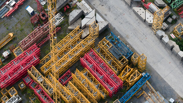 Aerial view of colorful crane components and lattice booms stored at Feluy de Parc Industriel in an industrial area, Seneffe, Region wallonne, Belgium.