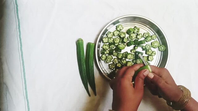  Top View of Fresh Green Okra or Lady Finger Being Sliced on Table