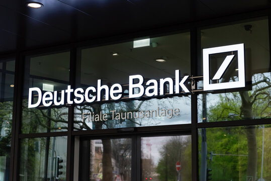 FRANKFURT, GERMANY - APRIL 4, 2026: An angled close-up view of the glowing Deutsche Bank Filiale Taunusanlage brand signage and corporate logo