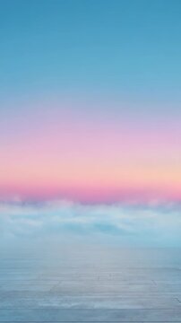 A serene pastel sky transitions from blue to pink above a smooth reflective floor, creating a peaceful and dreamy atmosphere. Ideal for digital backgrounds, presentations, and social media visuals