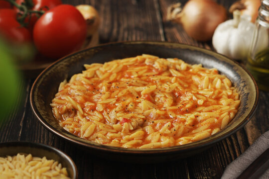 A bowl with traditional Greek soup Manestra with orzo pasta