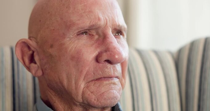 Thinking, sad and elderly man in home with memory, loss and remembrance of past mistake. Mental health, reflection or senior person with depression on sofa, emotional thoughts or regret in retirement