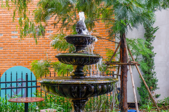 Luxury Fountain at green garden in house outdoor garden,Scenic View of a Beautiful English Style Landscape Garden in summer,selective focus.