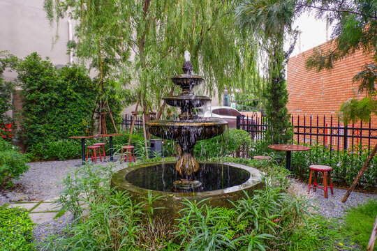Luxury Fountain at green garden in house outdoor garden,Scenic View of a Beautiful English Style Landscape Garden in summer,selective focus.