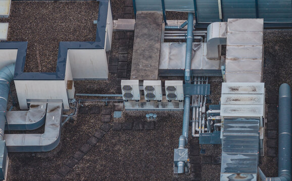 Aerial view of rooftop HVAC infrastructure featuring industrial ventilation ducts, air handling units, and mechanical systems on a commercial building in Valence, Auvergne-Rhone-Alpes, France.