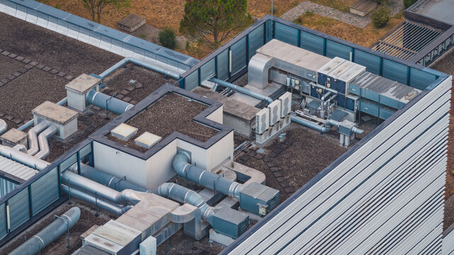 Aerial view of rooftop HVAC infrastructure featuring industrial ventilation ducts and cooling equipment on a modern building in Valence, Auvergne-Rhone-Alpes, France.