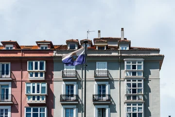 Old residential building facade in Santander, Spain, featuring balconies and dormer windows. © jjfarq