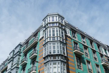 Old residential building facade in Santander, Spain, featuring balconies and dormer windows. © jjfarq