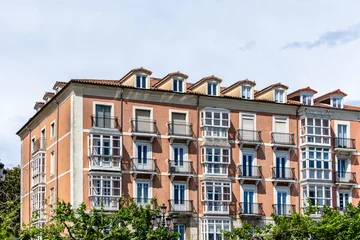 Old residential building facade in Santander, Spain, featuring balconies and dormer windows. © jjfarq