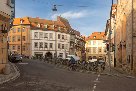 Street scene with traditional buildings, parked bicycles and historic architecture in the center of Bamberg, Bavaria, Germany.