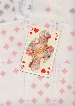 A montage of faded playing cards in the background with one card in focus.