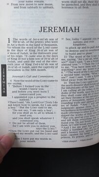 Kuala Lumpur, Malaysia - July 22nd, 2026: Opening to the Book of Joel of the Old Testament in the Holy Bible. New Revised Standard Version. Vertical video.