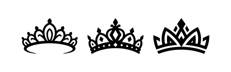 Three black silhouette crowns or tiaras on a white background, vector graphic © Lili