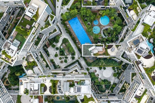 Aerial view of The Interlace residential complex featuring interconnected apartment blocks, lush rooftop gardens, and swimming pools in Singapore, Singapore.