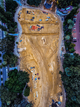 Aerial view of Supreme Court Gardens showing a cleared construction site with exposed earth, heavy machinery, and surrounding lush parkland trees in Perth, Western Australia, Australia.