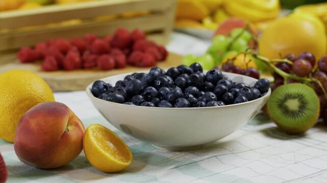 Bright, colorful, fresh fruit laid out on kitchen counter - tracking shot