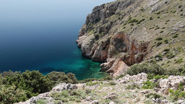 Mali Bok Beach, Cres Island, Croatia. Secluded cove, tranquil turquoise Adriatic Sea, crystal-clear water, rocky seabed, and dramatic cliffs.