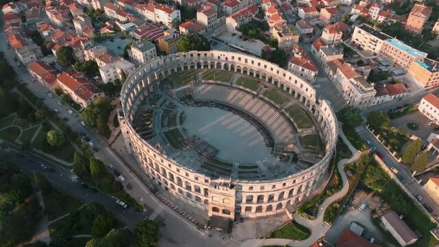 Aerial view of Pula Arena surrounded by historic buildings and streets in the city center of Pula, Istarska zupanija, Croatia.