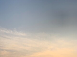 Obraz premium A peaceful sky with soft pastel tones and feather-like cloud formations above Jakarta, Indonesia. Ideal for weather, environmental, wellness, travel, and modern background applications requiring gener