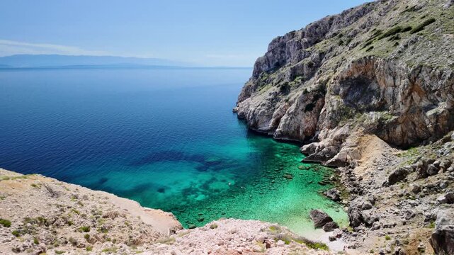 Mali Bok beach on Cres Island of Croatia featuring a secluded pebble cove with crystal clear turquoise Adriatic Sea water, reflecting sunny sky and surrounded by rocky cliffs in Cres Island of Croatia