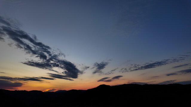 Silhouettes of hills and mountains in blue hour time.