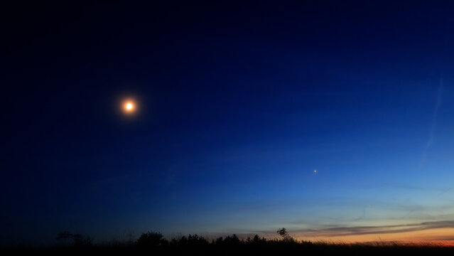 Moon, planet conjunction and landscape scenery silhouettes.