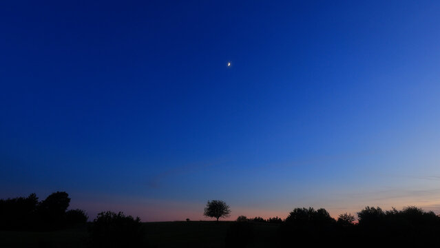 Moon, planet conjunction and landscape scenery silhouettes.