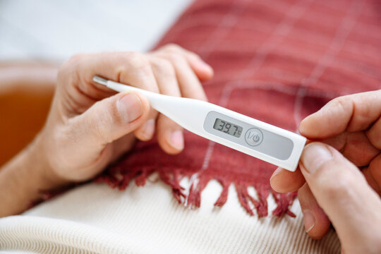 Man checking temperature using thermometer