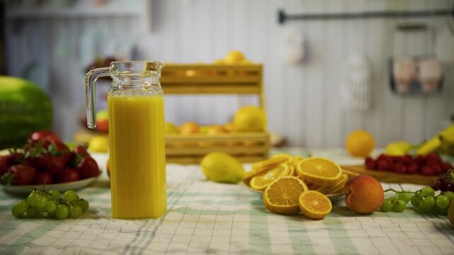 Orange juice and fresh fruit on kitchen counter - medium, tracking shot