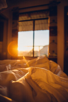 Close-up of crumpled sheet on bed during sunny day