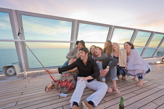 Group of friends taking selfies on a cruise