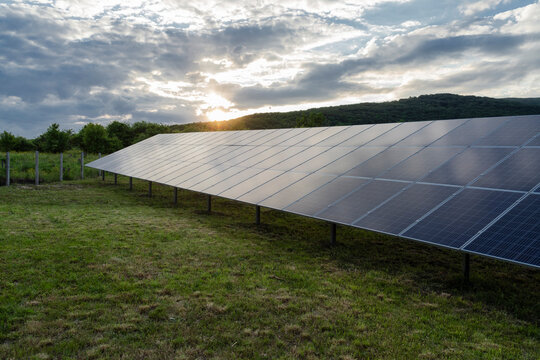 Solar panels on field under sky