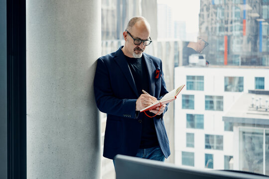 Businessman writes notes in a modern London office