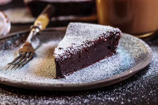 Swedish kladdkaka, dark chocolate cake, swedish brownie, with coffee, close-up