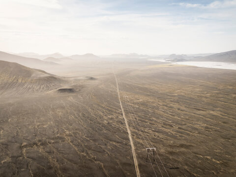 Transmission line crosses the desolate black sand in Iceland