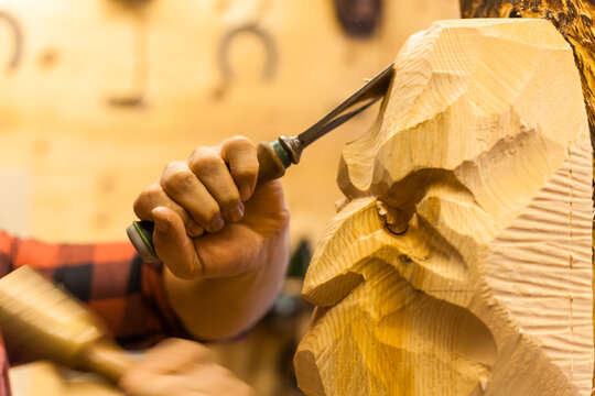 Wood carver manufacturing traditional Krampus mask