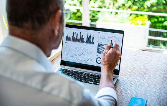 Man analyzes financial chart on notebook in the office