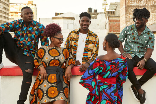 Friends in colorful clothes on roof terrace in the city, Maputo, Mozambique