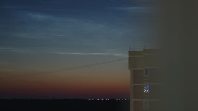 Noctilucent clouds or NLC in the summer sky on the northern hemisphere, on 56,5 degrees of latitude.