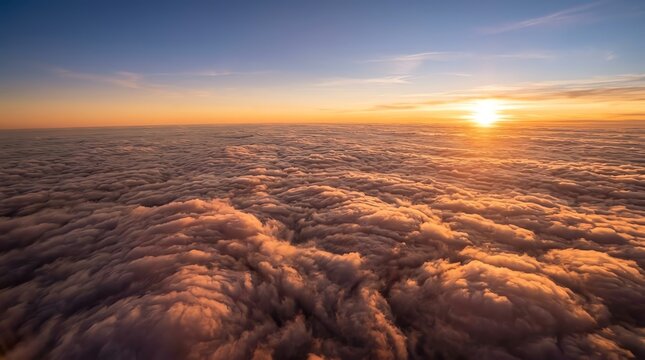 Sunset Over Clouds Scene with Vibrant Colors and Bright Sun Low on Horizon