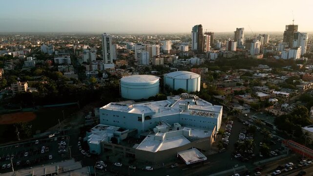 Aerial view of Hospital Dr. Dario Contreras with large water tanks and surrounding urban skyline in Santo Domingo Este, Santo Domingo, Dominican Republic.