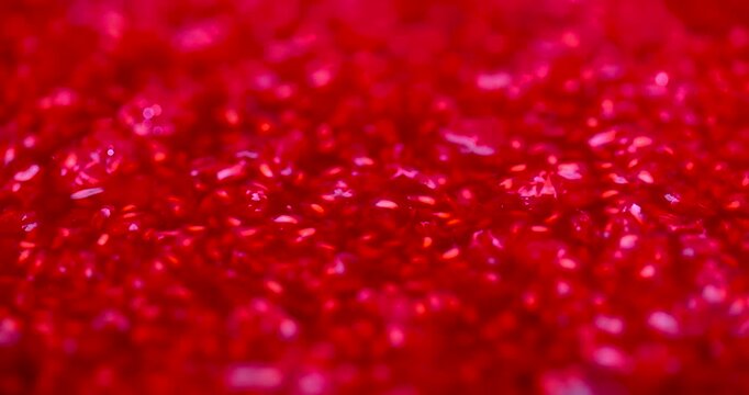 Grated raspberries are red in the form of a background, natural grated raspberries with white sugar grains fill the entire frame space.