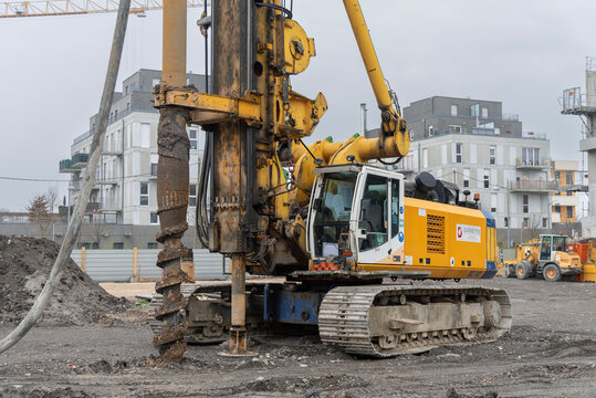 Nancy, France - March 1st 2019 : View on a yellow and blue drilling rig Bauer BG 40 for special foundations on a construction site before the construction of a residential building.