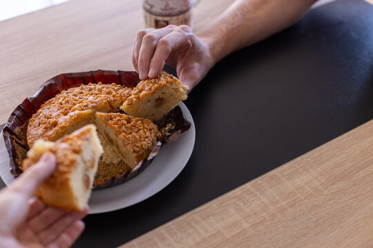 Male and Female Hands Taking Slices of Homemade Caramel Pie.
