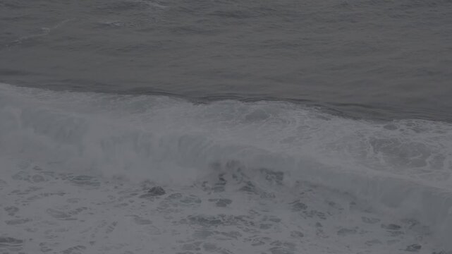Large waves rolled in the middle of the sea, with white foam visible. Elevated view, S-Log3, S-Gamut3.Cine