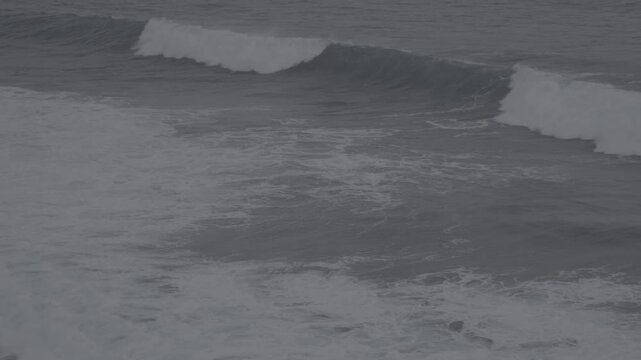 Large waves rolled in the middle of the sea, with white foam visible. Elevated view, S-Log3, S-Gamut3.Cine